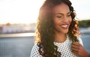 Beautiful afro american woman on a blurry background smiling