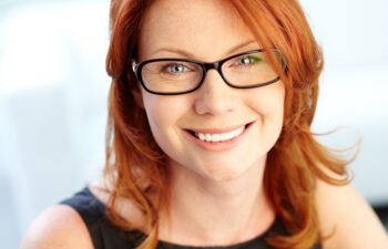 Close-up shot of a wonderful red-haired woman looking at camera