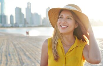 Portrait of beautiful young lady with spontaneous smile looking to the side. Authentic people enjoying life outdoor.