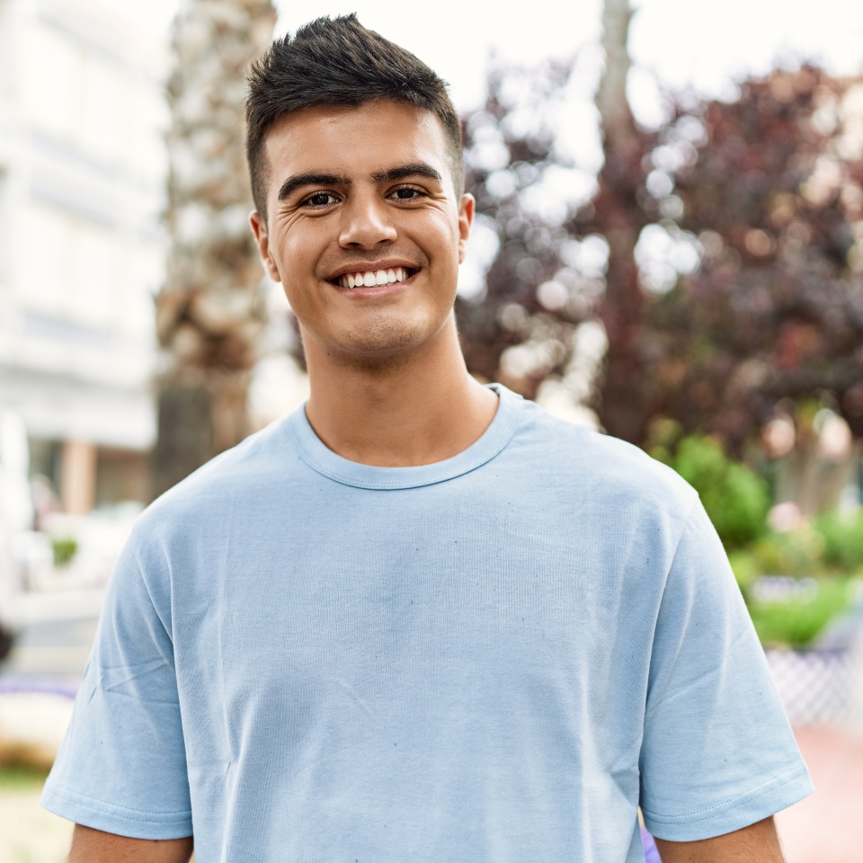 Young hispanic man smiling confident standing at street