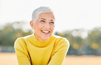 Portrait of an elderly woman outdoors. Happy senior woman in park